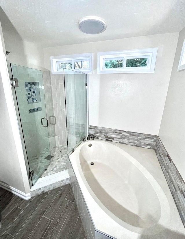 bathroom featuring a wealth of natural light and independent shower and bath