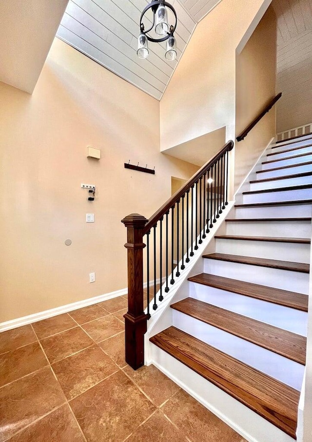 staircase featuring tile patterned floors and lofted ceiling