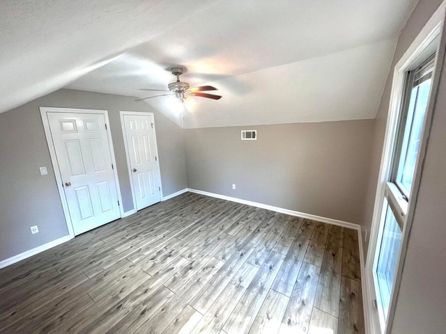 bonus room with hardwood / wood-style flooring, ceiling fan, a healthy amount of sunlight, and lofted ceiling