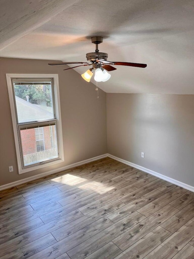 bonus room with ceiling fan, lofted ceiling, and light wood-type flooring