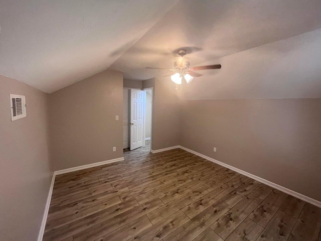 bonus room featuring ceiling fan, dark hardwood / wood-style flooring, and lofted ceiling