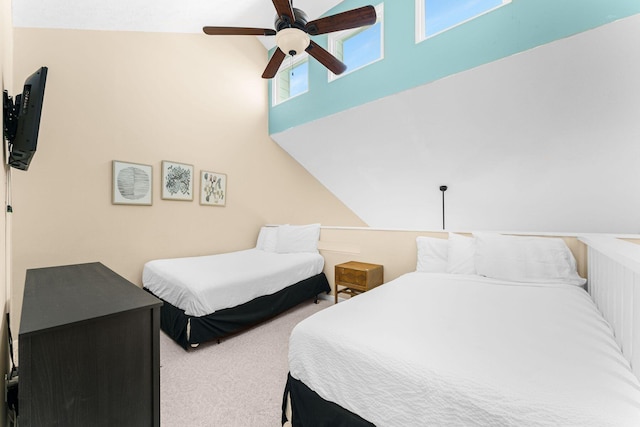 bedroom with carpet flooring, ceiling fan, and vaulted ceiling