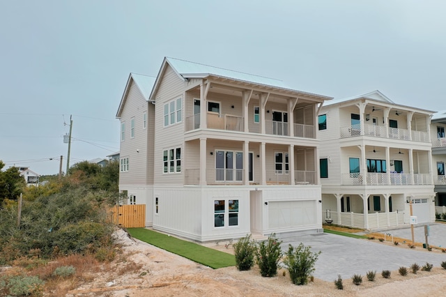 view of front of property featuring a garage and a balcony