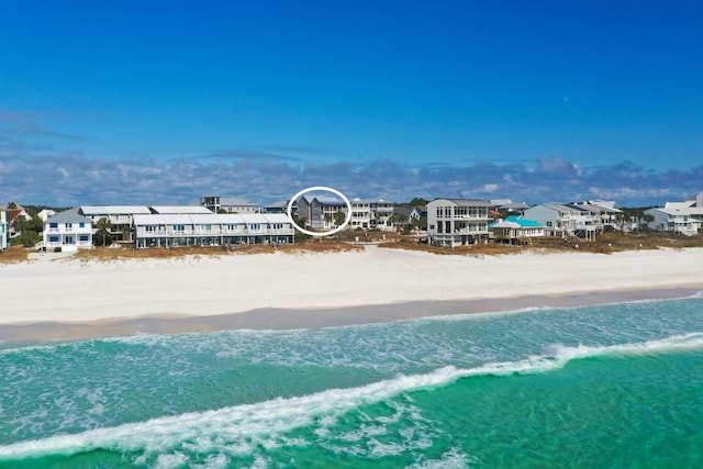 drone / aerial view featuring a water view and a view of the beach