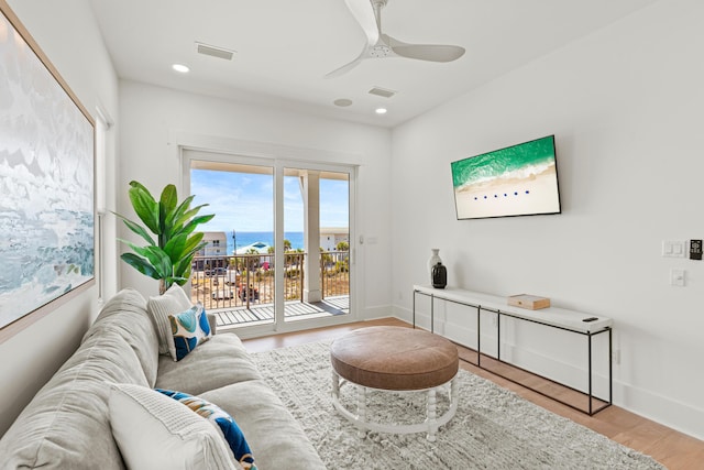 living room with hardwood / wood-style flooring and ceiling fan