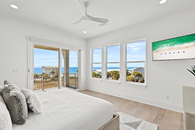 bedroom featuring a water view, ceiling fan, access to exterior, and light hardwood / wood-style floors