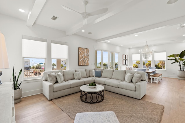 living room featuring beam ceiling, ceiling fan with notable chandelier, and light wood-type flooring