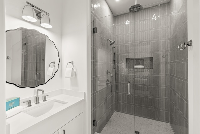 bathroom featuring vanity and an enclosed shower