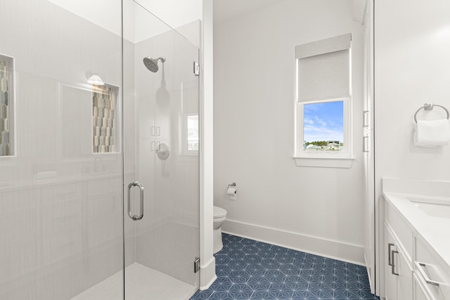 bathroom with vanity, a shower with shower door, and toilet