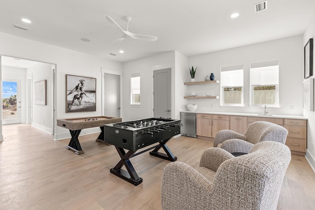 recreation room featuring ceiling fan and light wood-type flooring