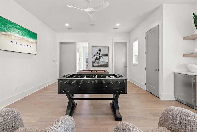 recreation room featuring ceiling fan and light wood-type flooring