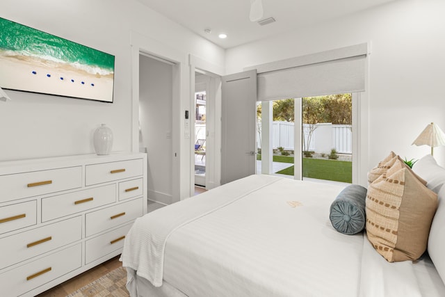 bedroom with wood-type flooring and access to outside