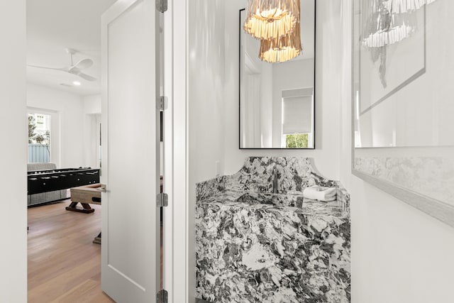 bathroom featuring hardwood / wood-style flooring, sink, and a chandelier