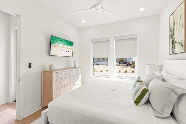 bedroom with ceiling fan and light hardwood / wood-style floors