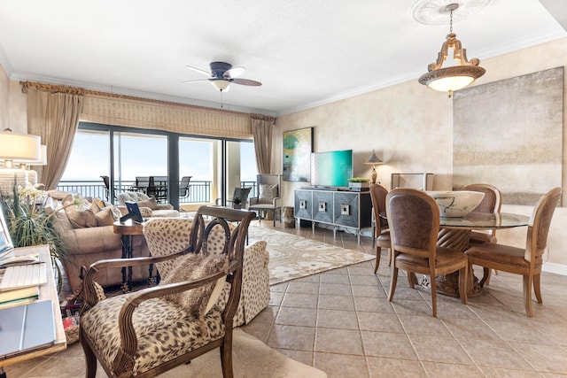 tiled living room featuring ceiling fan and ornamental molding