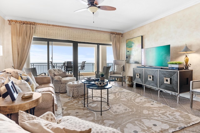 living room with a water view, ceiling fan, and ornamental molding