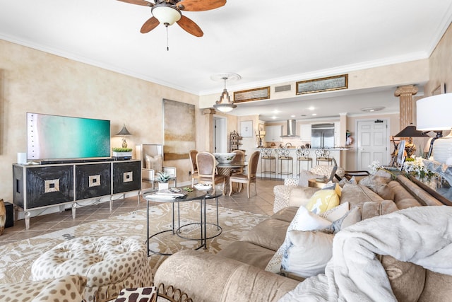 living room with tile patterned floors, ceiling fan, and crown molding