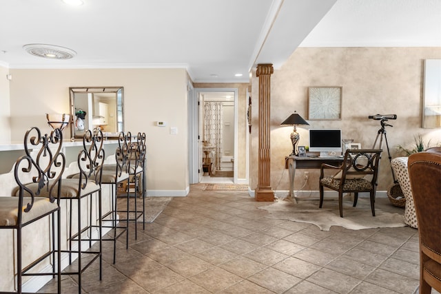 interior space featuring crown molding and decorative columns