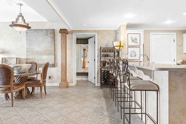 dining room featuring decorative columns and crown molding