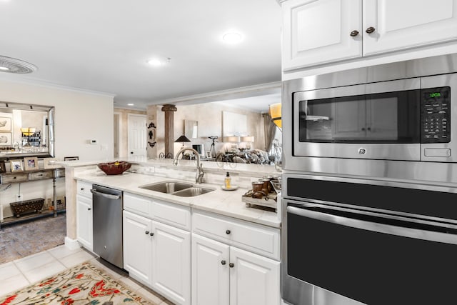 kitchen featuring sink, white cabinetry, stainless steel appliances, and light tile patterned floors