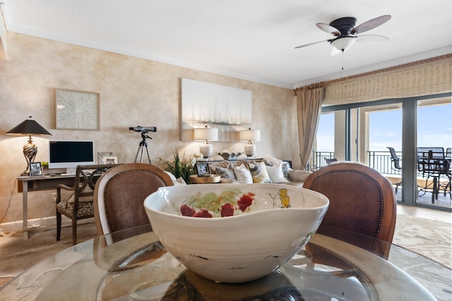 dining space with ceiling fan and crown molding