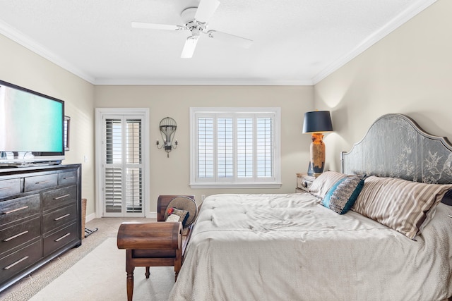 carpeted bedroom with ceiling fan and ornamental molding