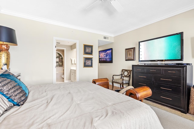 carpeted bedroom with ceiling fan, crown molding, and ensuite bath