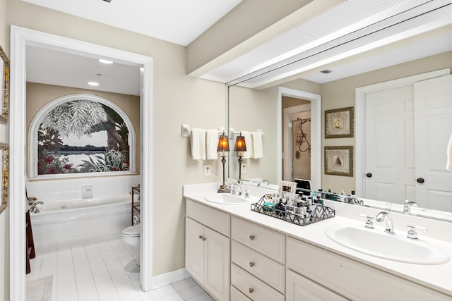 bathroom featuring tile patterned floors, a washtub, toilet, and vanity