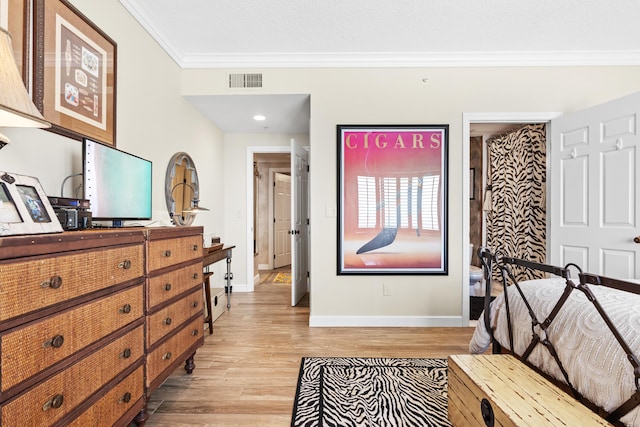 bedroom with light hardwood / wood-style floors and ornamental molding