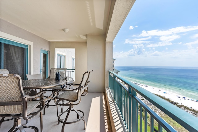 balcony with a water view and a beach view