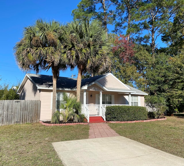 view of front of property with covered porch and a front yard