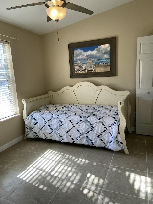 tiled bedroom with ceiling fan and vaulted ceiling