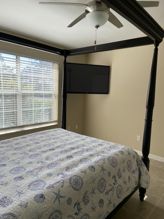 tiled bedroom featuring ceiling fan