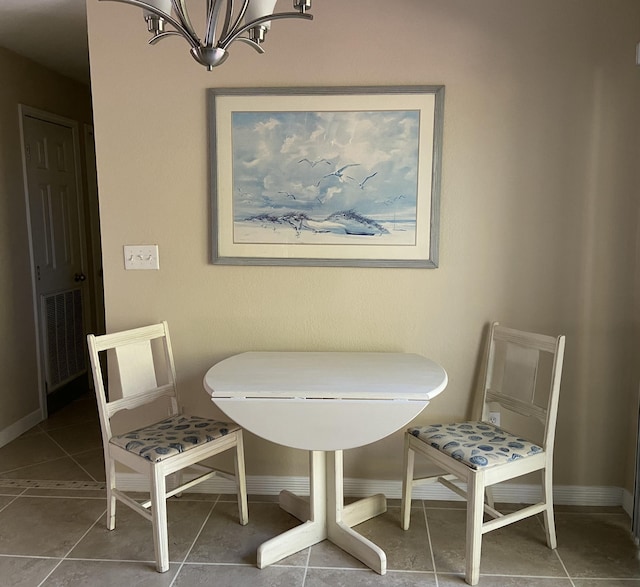 tiled dining room with a notable chandelier