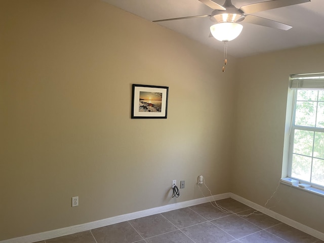 laundry room featuring ceiling fan and tile patterned flooring