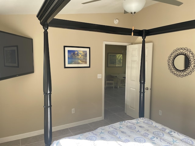 bedroom with ceiling fan, dark tile patterned floors, and vaulted ceiling