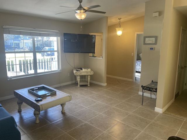 tiled living room featuring lofted ceiling, ceiling fan, and a healthy amount of sunlight