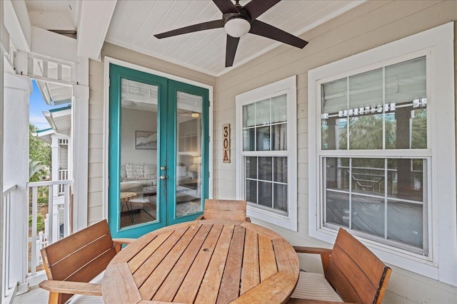 sunroom / solarium featuring ceiling fan