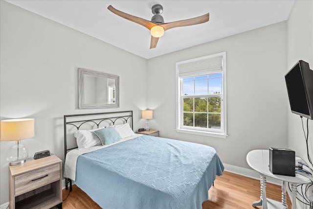 bedroom with light hardwood / wood-style floors and ceiling fan