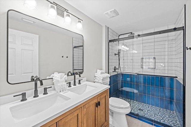 bathroom featuring vanity, toilet, and walk in shower