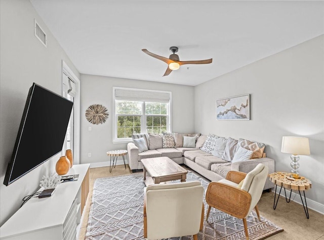 tiled living room with ceiling fan