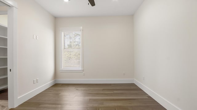 empty room with hardwood / wood-style floors and ceiling fan