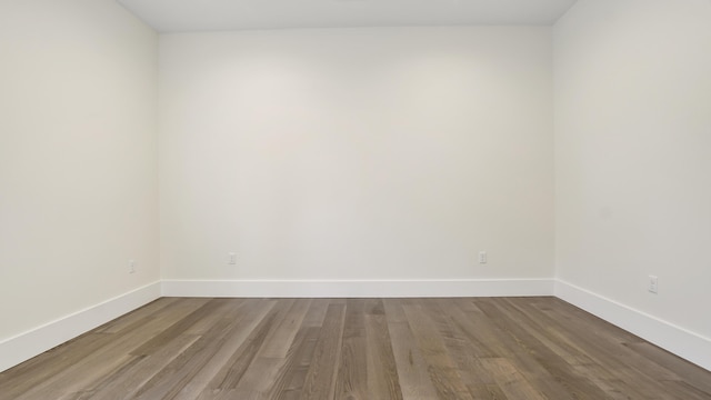 spare room with wood-type flooring