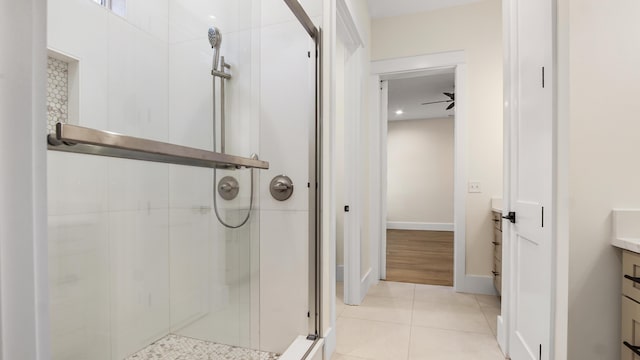 bathroom featuring tile patterned floors, ceiling fan, vanity, and walk in shower