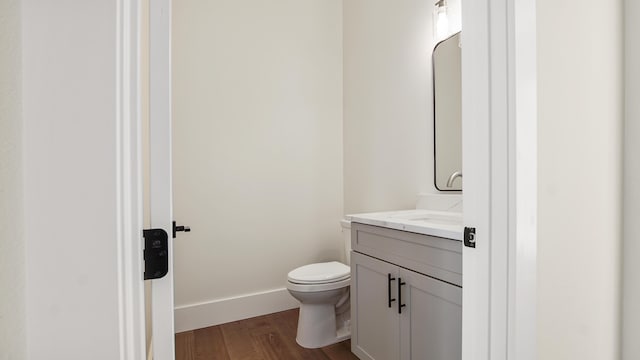 bathroom featuring hardwood / wood-style floors, vanity, and toilet