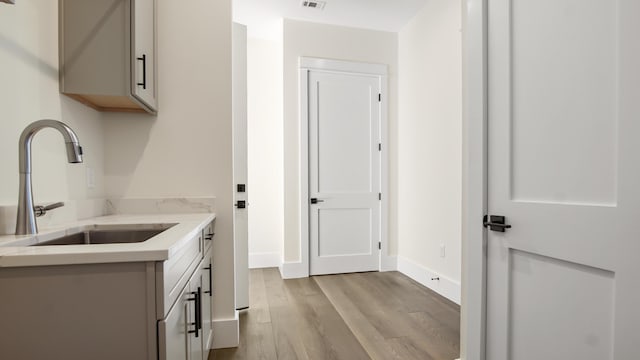 interior space featuring sink and light hardwood / wood-style flooring