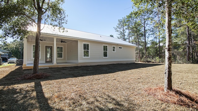 rear view of property with ceiling fan and covered porch