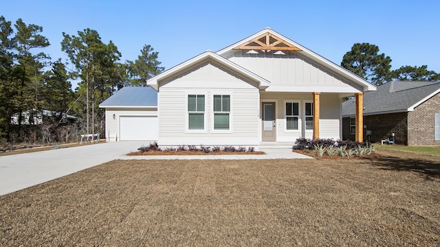 view of front of house with a porch, a garage, and a front yard