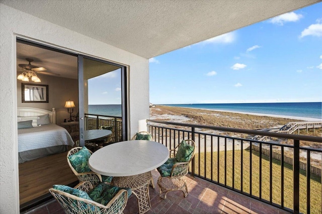 balcony with a water view and a beach view