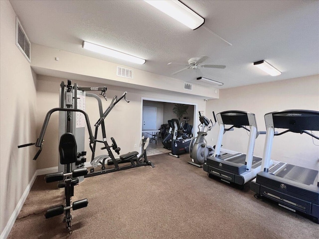 exercise room featuring ceiling fan and a textured ceiling